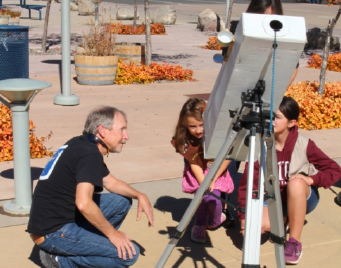 President Dennis Jamison with a Junior Astronmer and Telescope